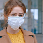 Women outside with a medical mask on