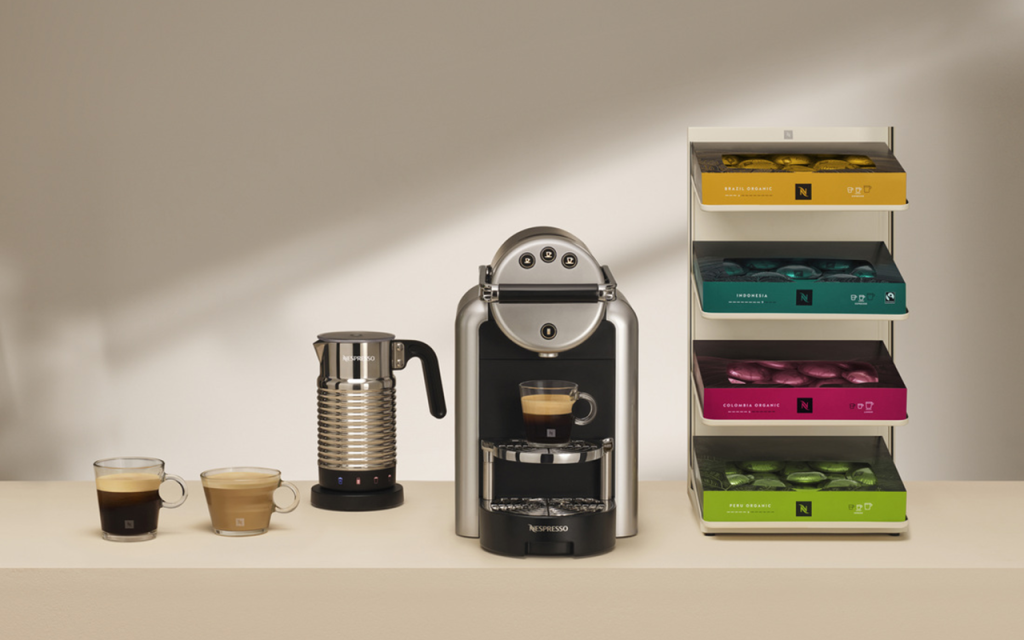 Coffee machine, milk frother and capsule display on a counter