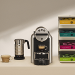 Coffee machine, milk frother and capsule display on a counter