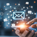 Hand touching a glowing email icon surrounded by chat bubbles