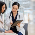 Clinician and patient reviewing a tablet during a consultation