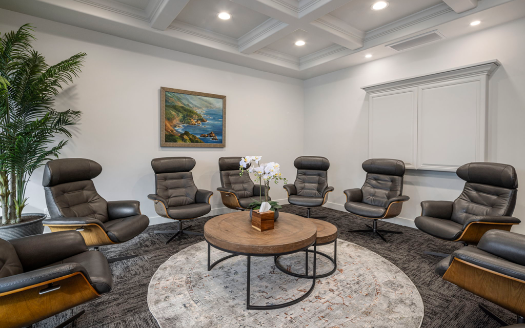 Group room with recliners around a round table at Redefine Wellness & Treatment