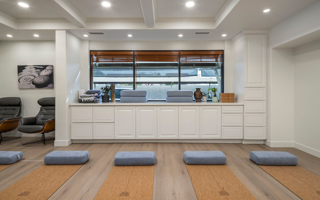 Wellness room with recliners, floor cushions and a counter at Redefine Wellness & Treatment