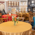 Dining table set in front of a miniature village of storefronts at The Little Play Avenue